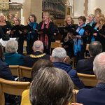 Incatata singing at a performance inside a church