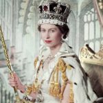 A colour photograph of Queen Elizabeth 2nd coronation. The Queen is sat on a green and gold chair wearing full regalia and looking directly at the camera.
