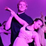 Three young couples dancing bathed in purple light