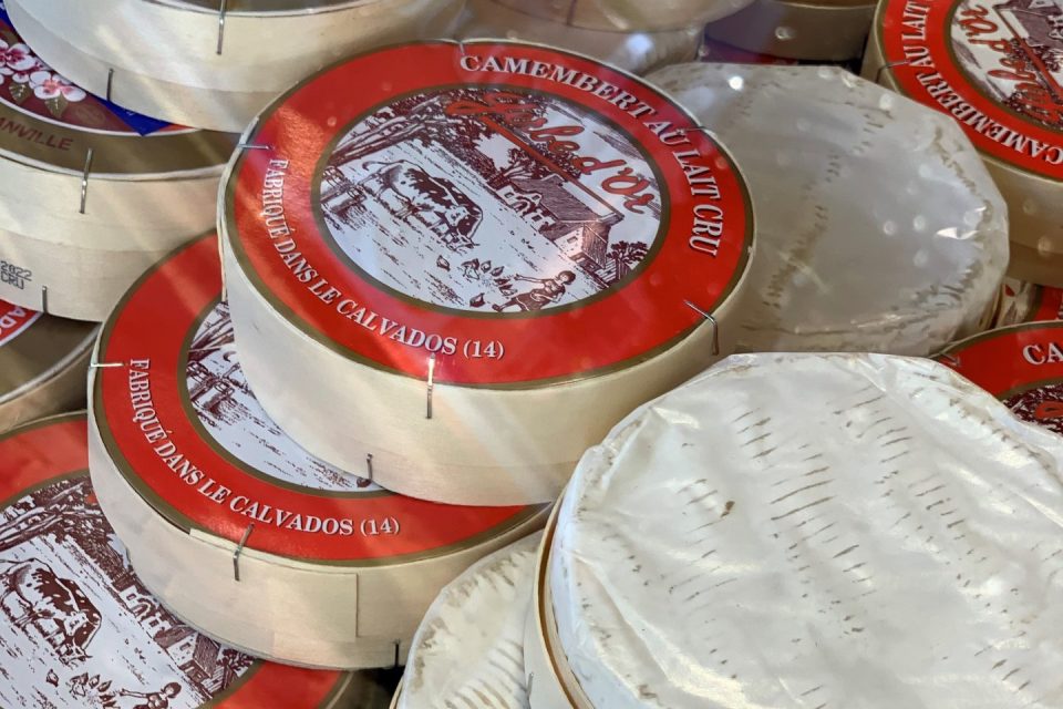 A close up of a display of wheels of camembert